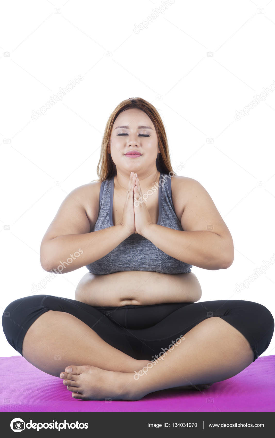 Overweight woman practicing yoga on studio — Stock Photo © realinemedia