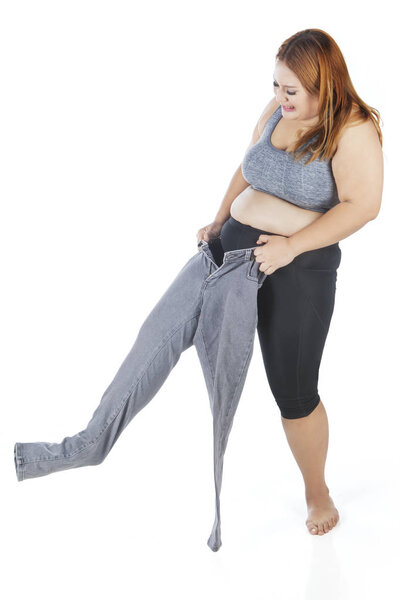 Overweight woman wearing old jeans