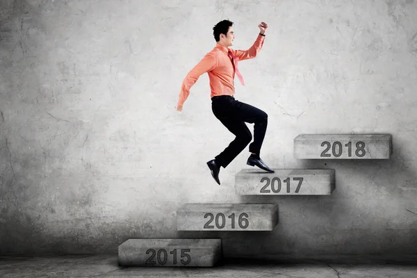 Entrepreneur steps on stairs with number 2017 — Stock Photo, Image