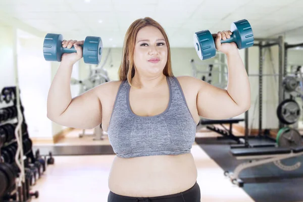 Fat woman doing exercise with dumbbell — Stock Photo, Image