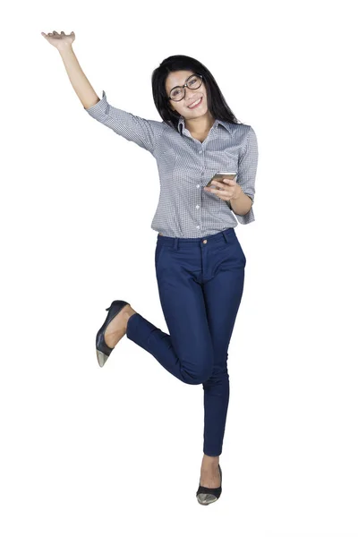 Female entrepreneur with mobile phone on studio — Stock Photo, Image