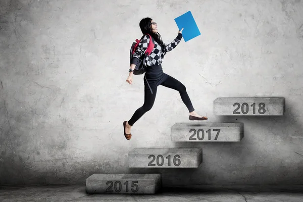 Female student running on stairs with folder — Stock Photo, Image