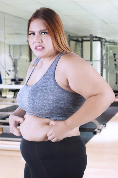 Blonde woman pinching her belly fat — Stock Image Blonde woman pinching her belly fat Stock Picture