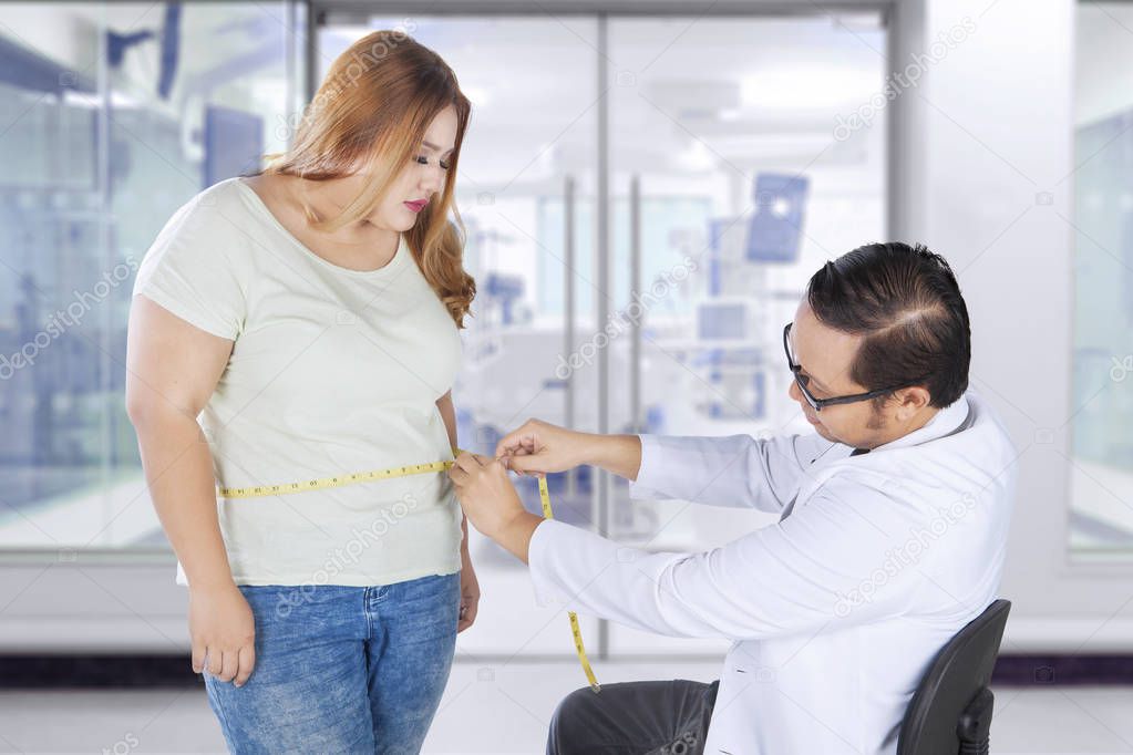 Doctor examines fat woman at hospital 