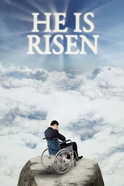 Disabled man with text he is risen on the sky — Stock Photo, Image