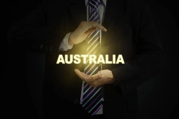 Männlicher Unternehmer schützt ein Wort von Australien — Stockfoto