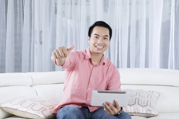 Young man with tablet showing OK sign — Stock Photo, Image
