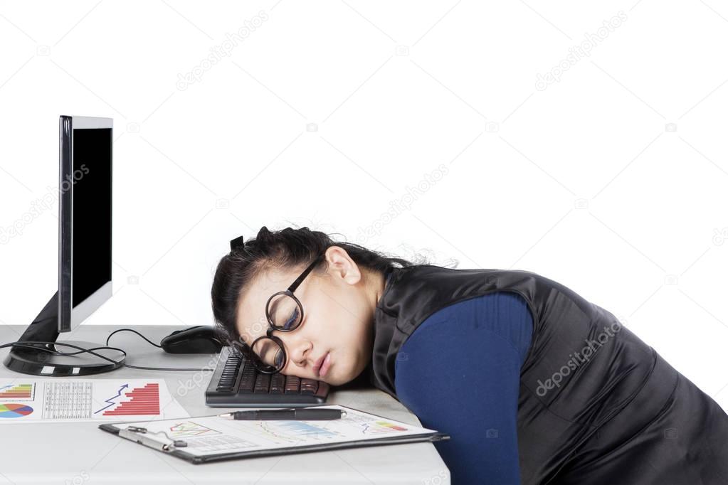 Young woman sleeps on desk 