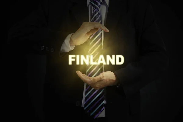 Homme d'affaires tenant mot Finlande — Photo