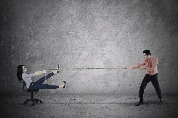 Businessman pulling his partner with rope — Stock Photo, Image