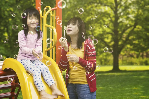 Schöne Mutter und Kind spielen Blasen — Stockfoto