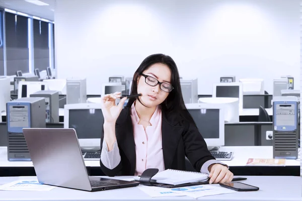 Beautiful businesswoman thinking something with a document — Stock Photo, Image
