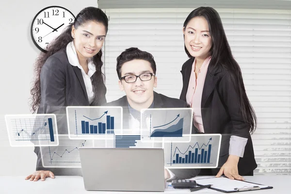 Multi ethnic accountants with graph on laptop — Stock Photo, Image