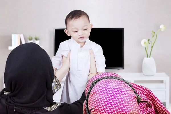 Moslim ouders hijs zoon in woonkamer — Stockfoto