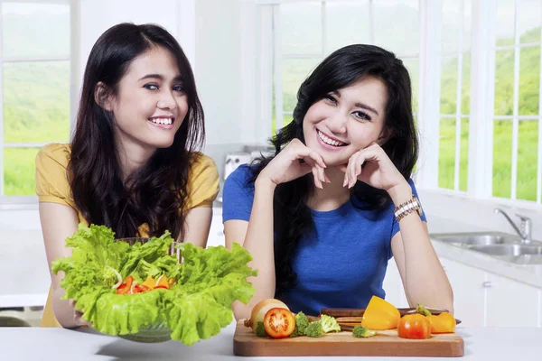 Twee gezonde meiden houdt een kom met salade — Stockfoto