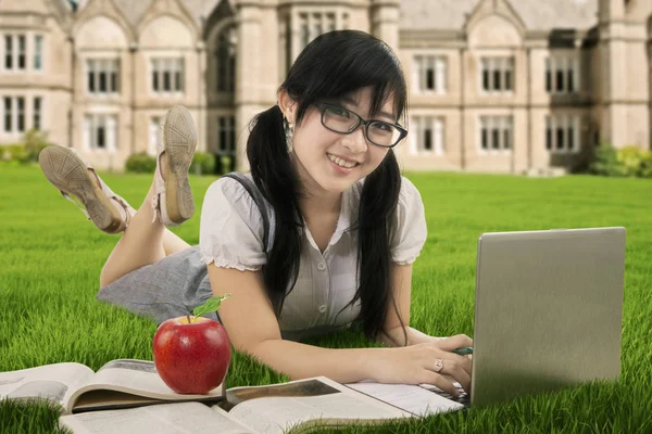 Schöne asiatische Student lernt auf dem Feld — Stockfoto