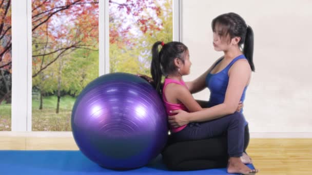 Mujer e hija con pelota de fitness — Vídeos de Stock