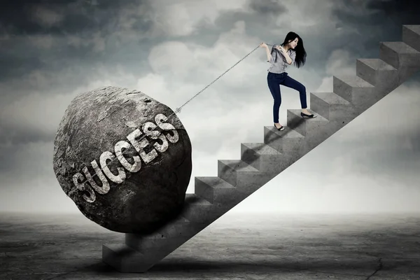 Businesswoman pulling success word on stair — Stock Photo, Image