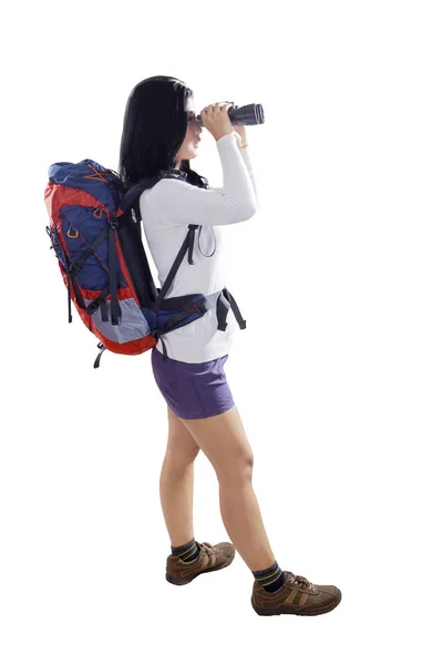 Female hiker using binocular on studio — Stock Photo, Image