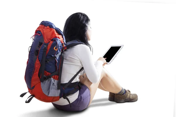 Female hiker with digital tablet on studio — Stock Photo, Image