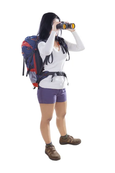 Young female with binoculars on studio — Stock Photo, Image