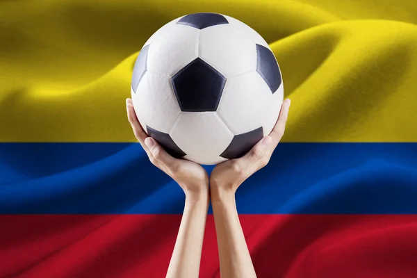 Ball on the hands with flag of Colombia — Stock Photo, Image