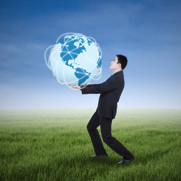 Businessman holding an earth planet — Stock Photo, Image