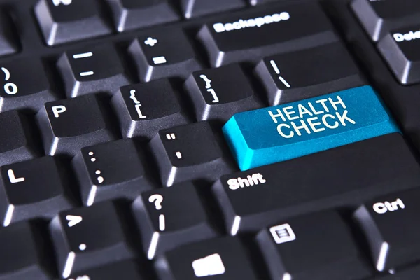 Текст перевірки здоров'я на синій кнопці — стокове фото