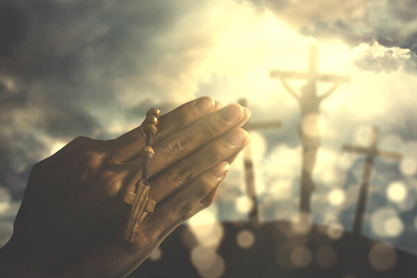 Hands of a Christian man with rosary