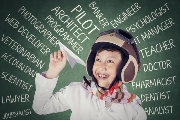 Boy with his dreams holds a paper plane — Stock Photo, Image
