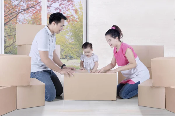 Familie packt Karton zu Hause ein — Stockfoto