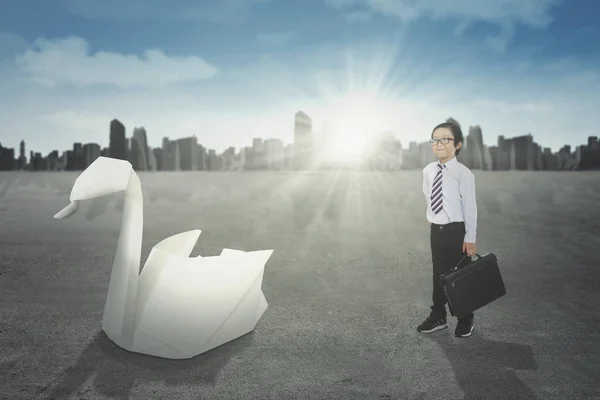 Little boy and big origami swan — Stock Photo, Image