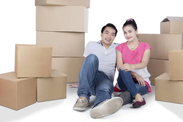 Young couple with boxes on studio — Stock Photo, Image