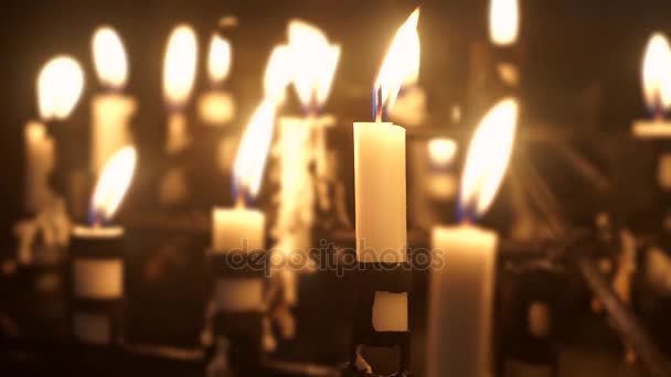 Candles flame in church shining at night — Stock Video