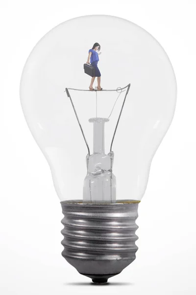 Businesswoman walking carefully in lamp — Stock Photo, Image