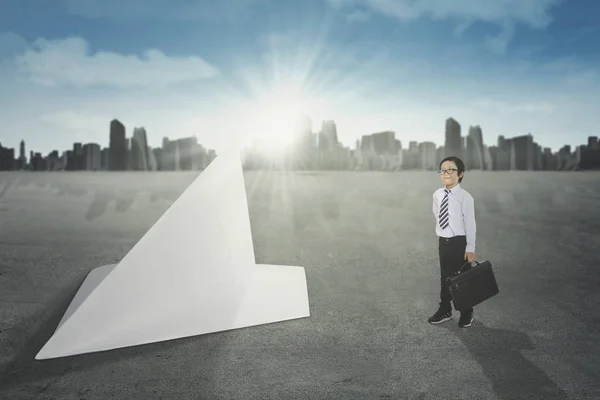 Little entrepreneur with paper airplane — Stock Photo, Image