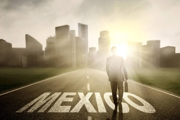 Manager walking above Mexico word at sunrise — Stock Photo, Image