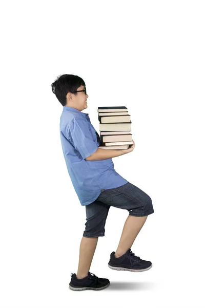 Boy hold pilha de livros em estúdio — Fotografia de Stock