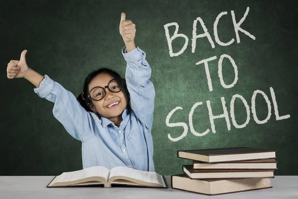 Schoolgirl shows ok sign with back to school word — Stock Photo, Image