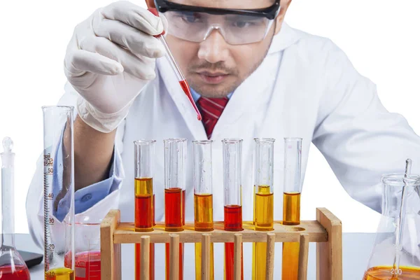 Research worker pouring chemical liquid Stock Photo
