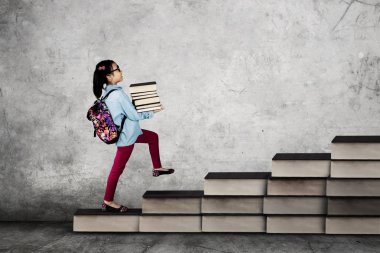 Kitap taşıyan küçük okul kız