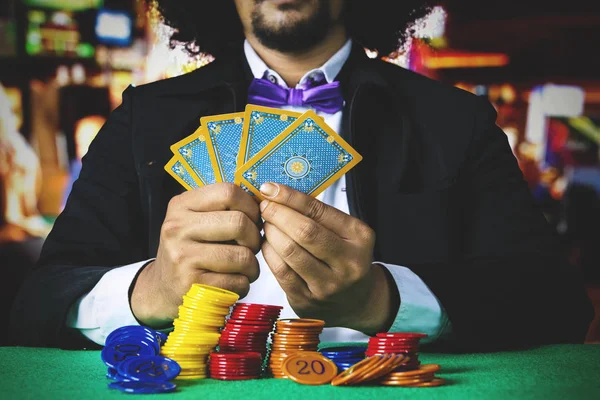 Gambler holds poker cards — Stock Photo, Image