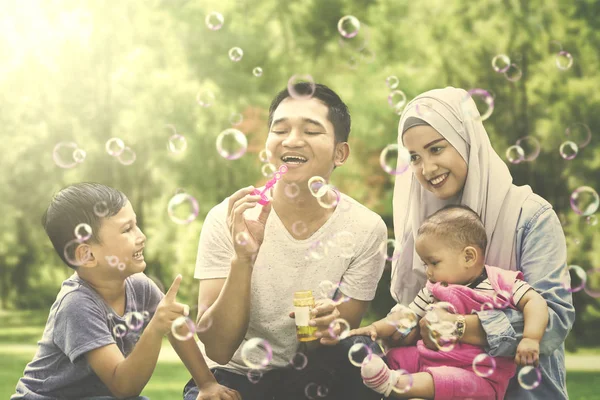 Muslim family playing with soap bubble — Stock Photo, Image