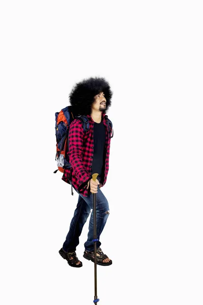 Afro man walks with a stick pole — Stock Photo, Image