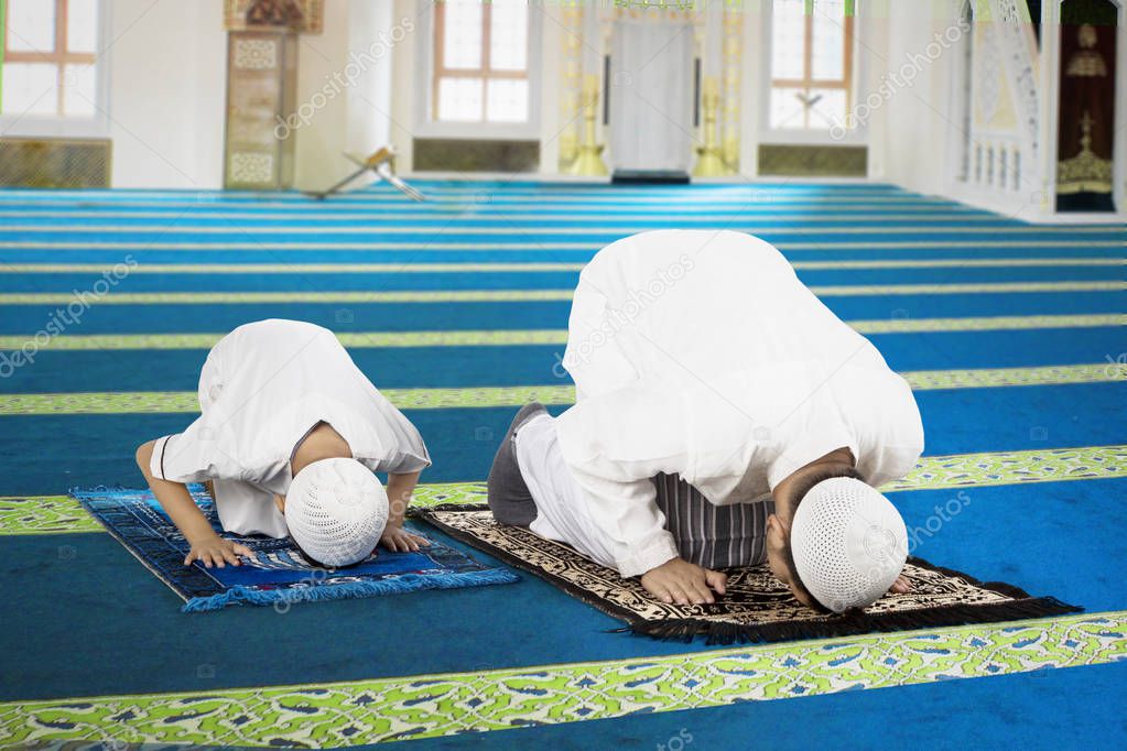 Devout family is prostration in the mosque