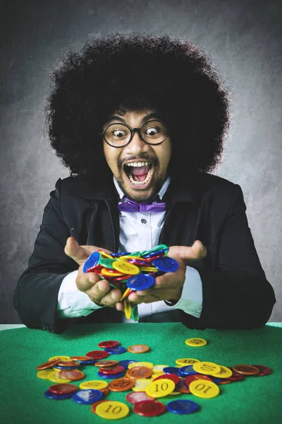 Lucky gambler holds gambling chips — Stock Photo, Image