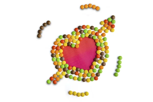 Multi gekleurde snoepjes vormige hartsymbool — Stockfoto