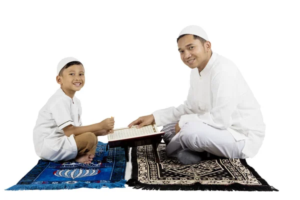 Father and son smiling with Quran — Stock Photo, Image