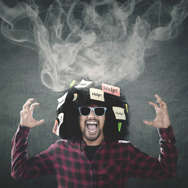 Frustrated Afro man with smoke on head — Stock Photo, Image