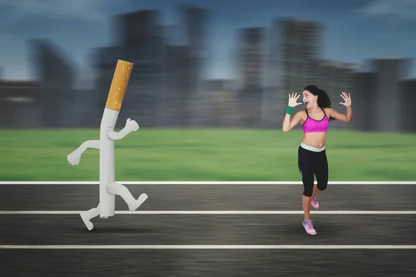 Indian woman running away from a cigarette